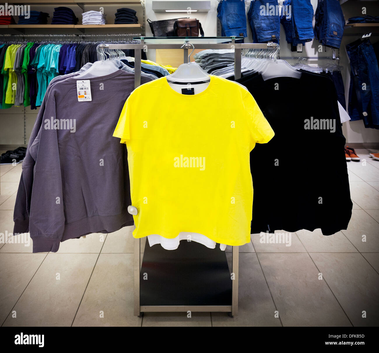 Close up of sweater, sweatshirts and t-shirt on retail shop rack. Store interior. Stock Photo