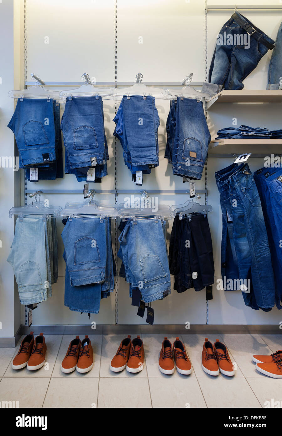 Jeans, trousers and shoes in retail shop interior. Store display with rack,  shelf Stock Photo - Alamy