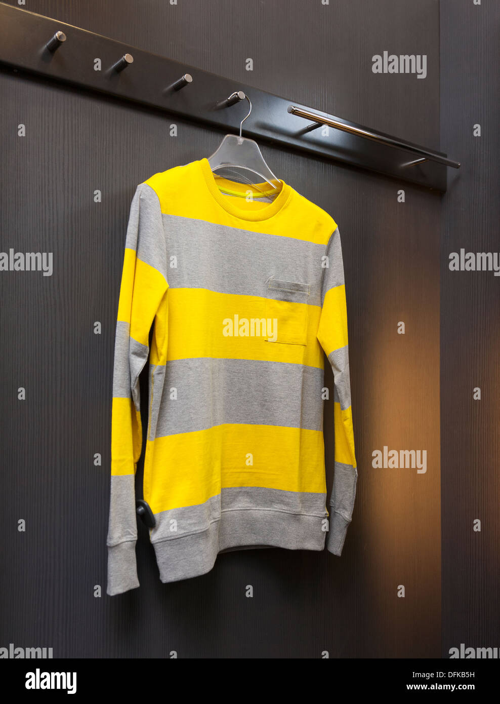 Close up of sweater, sweatshirt in retail shop dressing cabin. Changing room. Stock Photo
