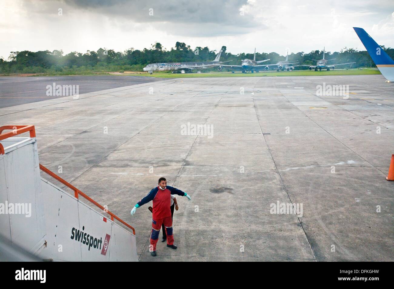 Security personel checking a maintenance person before entering the plane, Manaus  Amazonas state, the Amazon, Brazil. Stock Photo