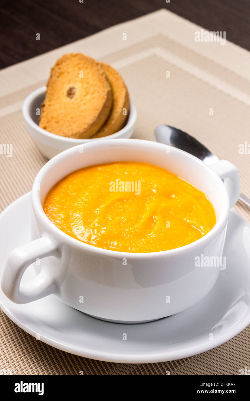 Pumpkin soup in white bowl with crouton Stock Photo - Alamy