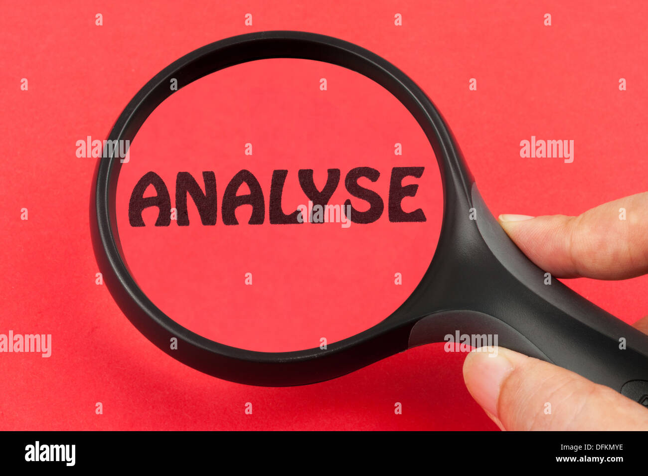 Analysing using a magnifier tool on hand Stock Photo