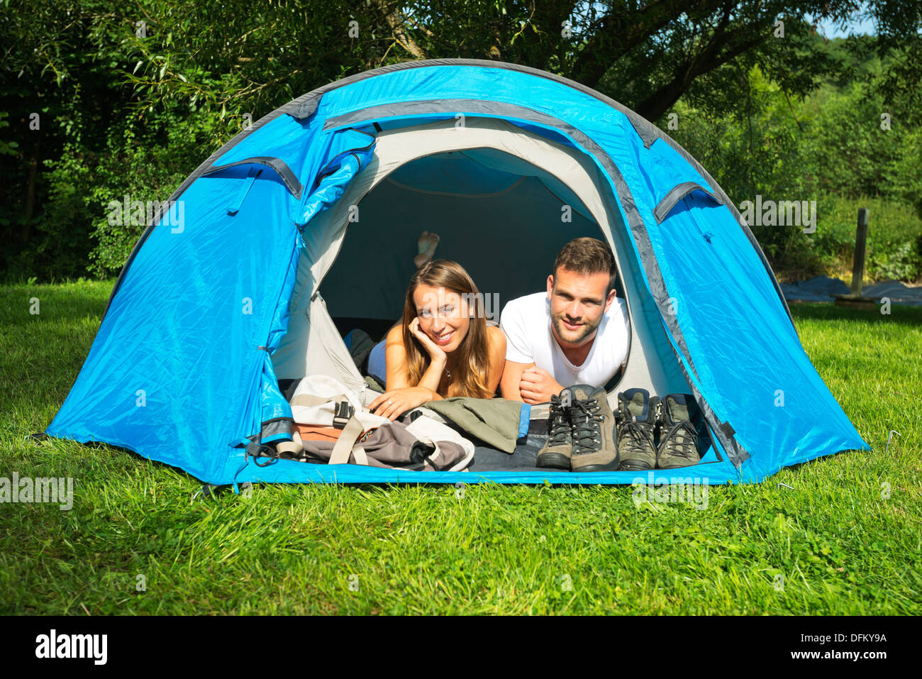 Portrait of a young couple lying in a tent Stock Photo