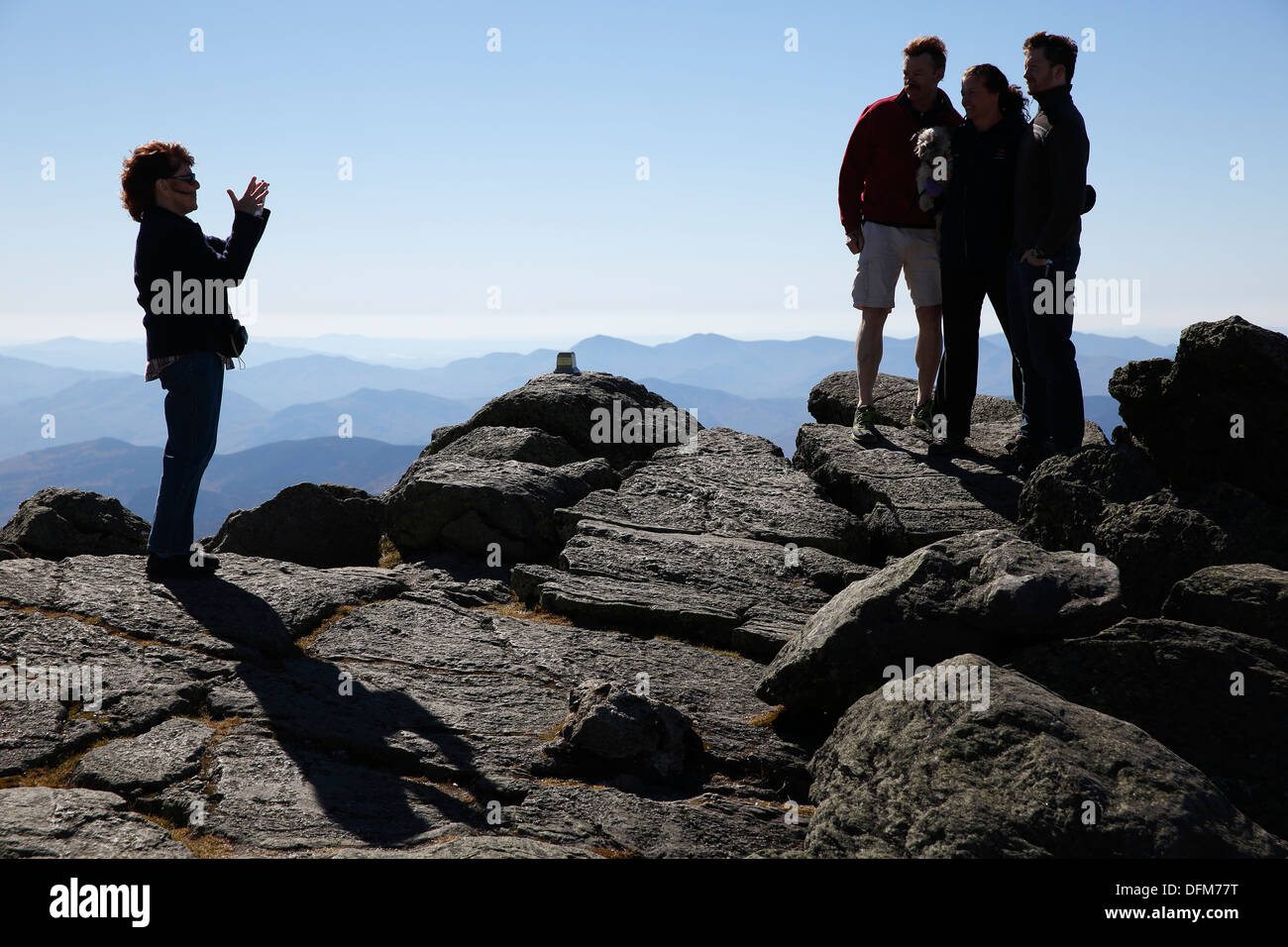 Tourists pose for smartphone photo on the summit of Mount Washington, New Hampshire, USA Stock Photo