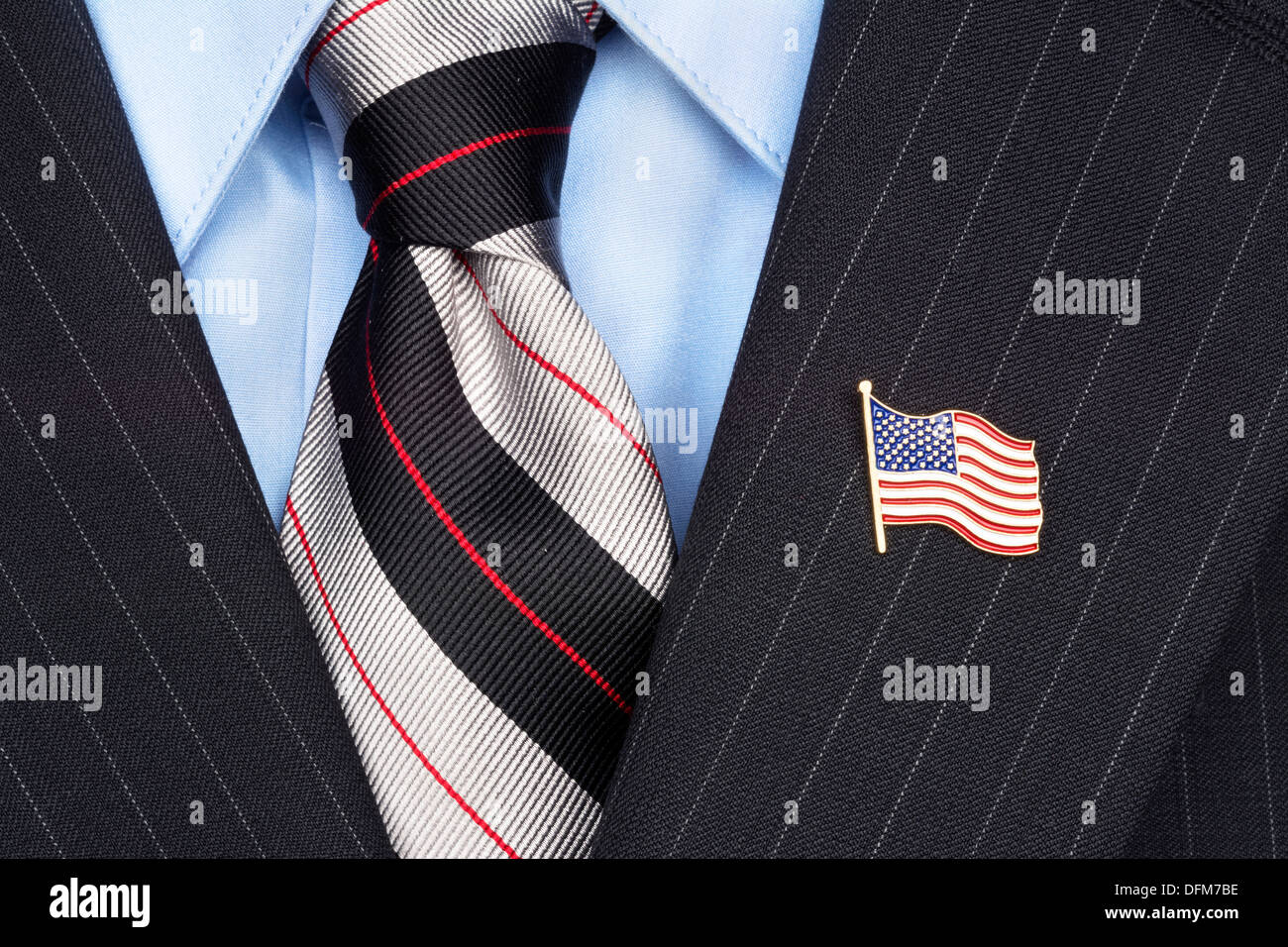 A symbolic American flag lapel pin on the collar of a businessman's suit Stock Photo