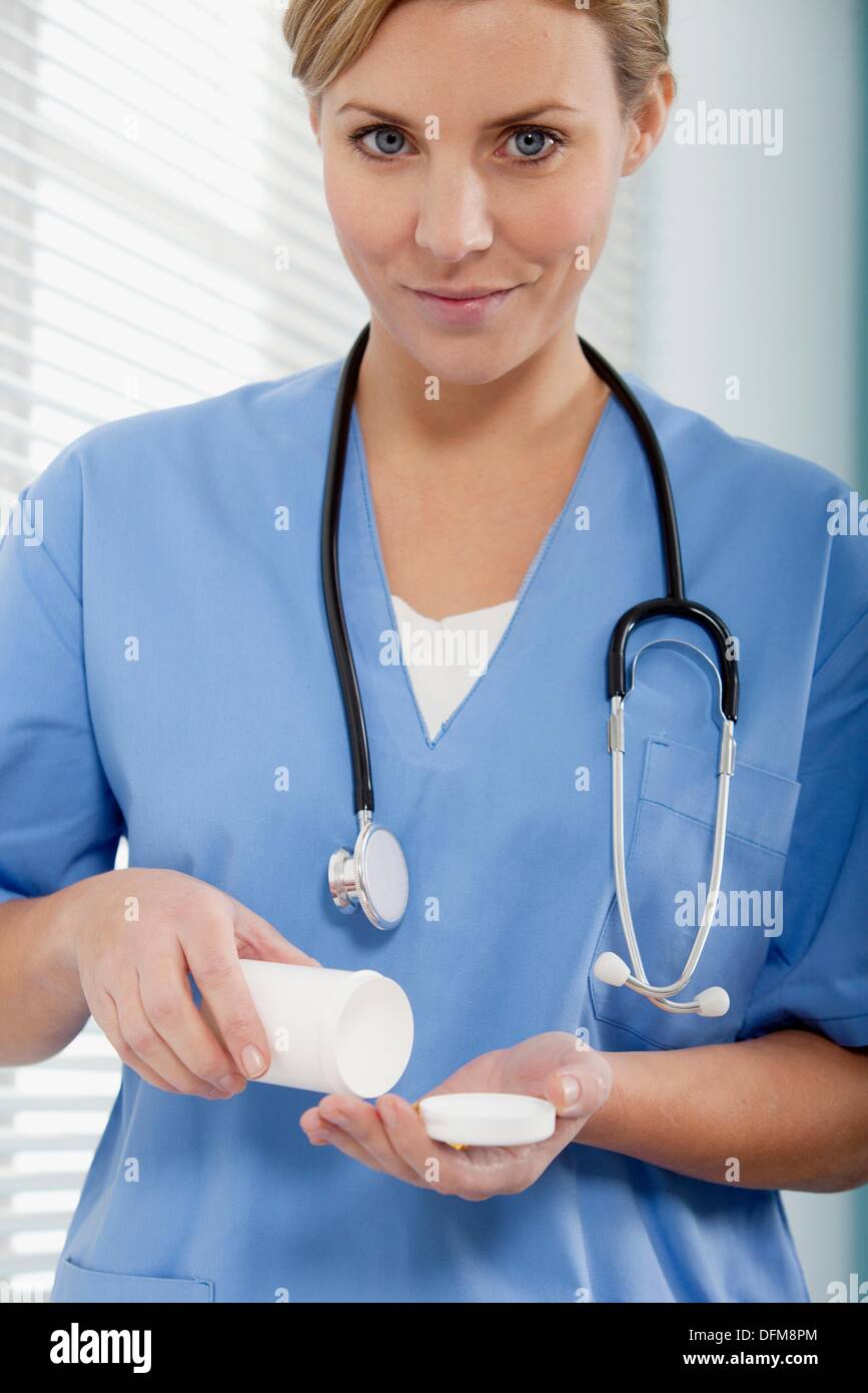 Female Nurse dispensing medicine Stock Photo Alamy