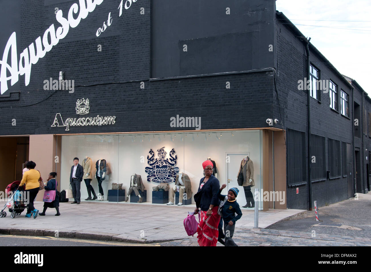 Hackney, London 2013. Aquascutum. Part of the new textile quarter with  mothers and children walking home from school Stock Photo - Alamy
