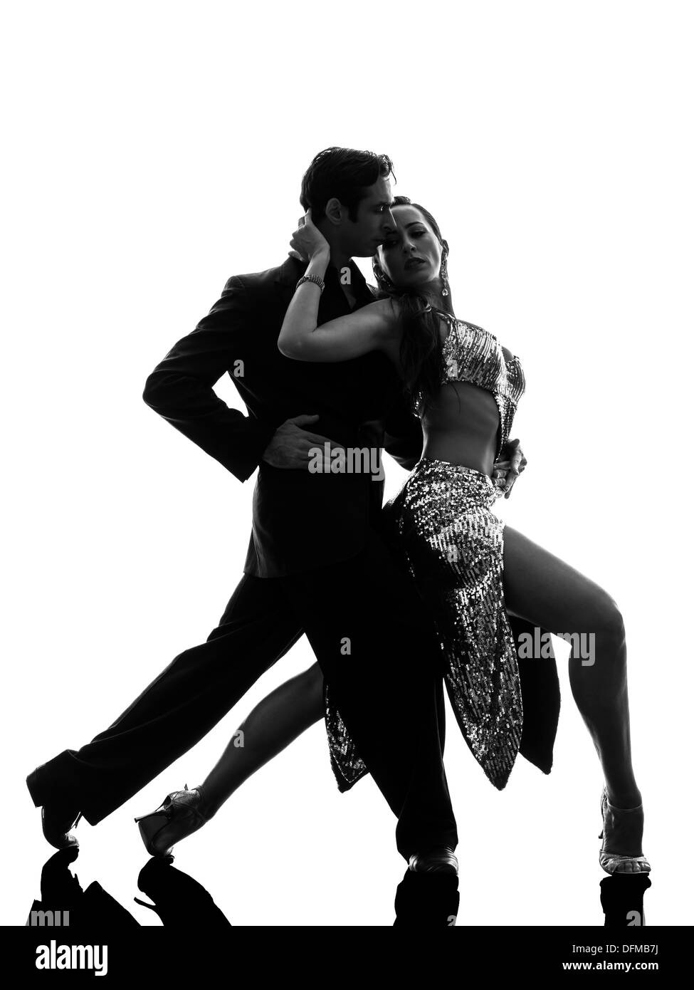 one  couple man woman ballroom dancers tangoing in silhouette studio isolated on white background Stock Photo