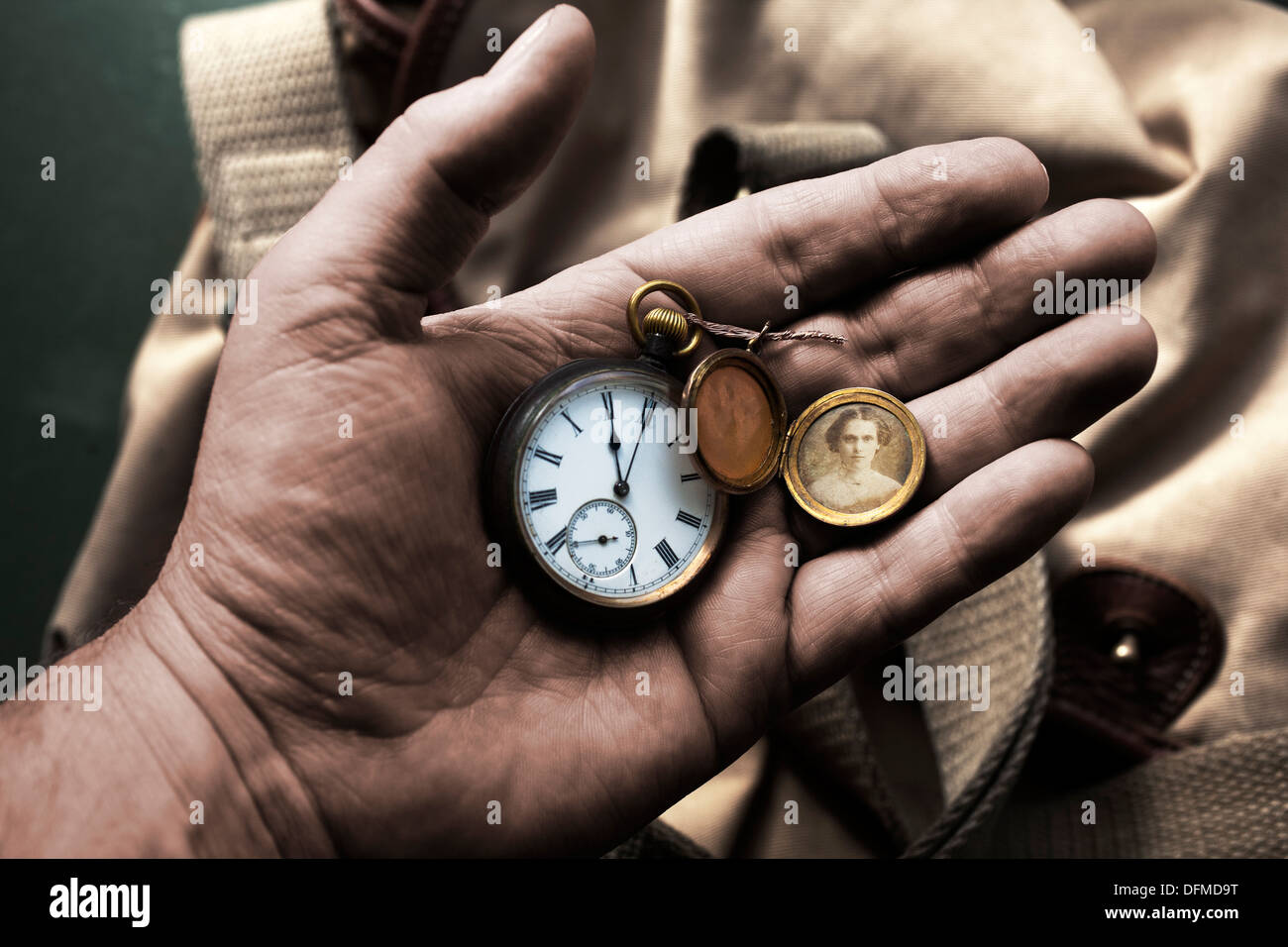 World War 1, One, Soldier's ,hand, holding, pocket ,watch ,showing,11 am ,11 o clock, with, locket ,showing, a, picture, of his, sweet heart,close up, Stock Photo