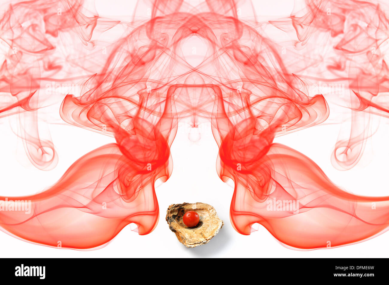 Red tomato on a seashell surrounded by a symmetrical composition of red smoke formed from Stock Photo