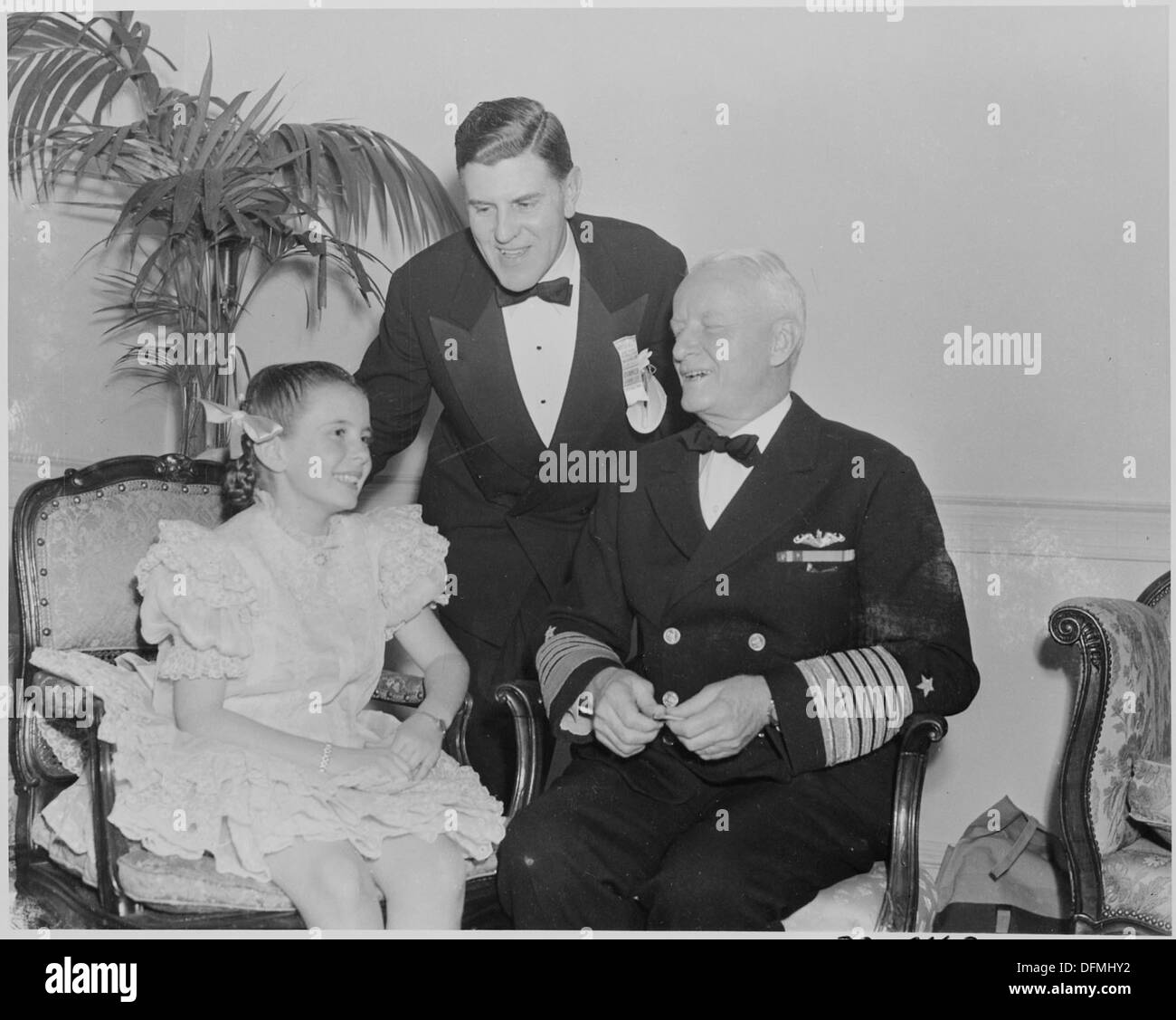 Photograph of actress Margaret O'Brien with Admiral Chester Nimitz and an unidentified man. 199318 Stock Photo