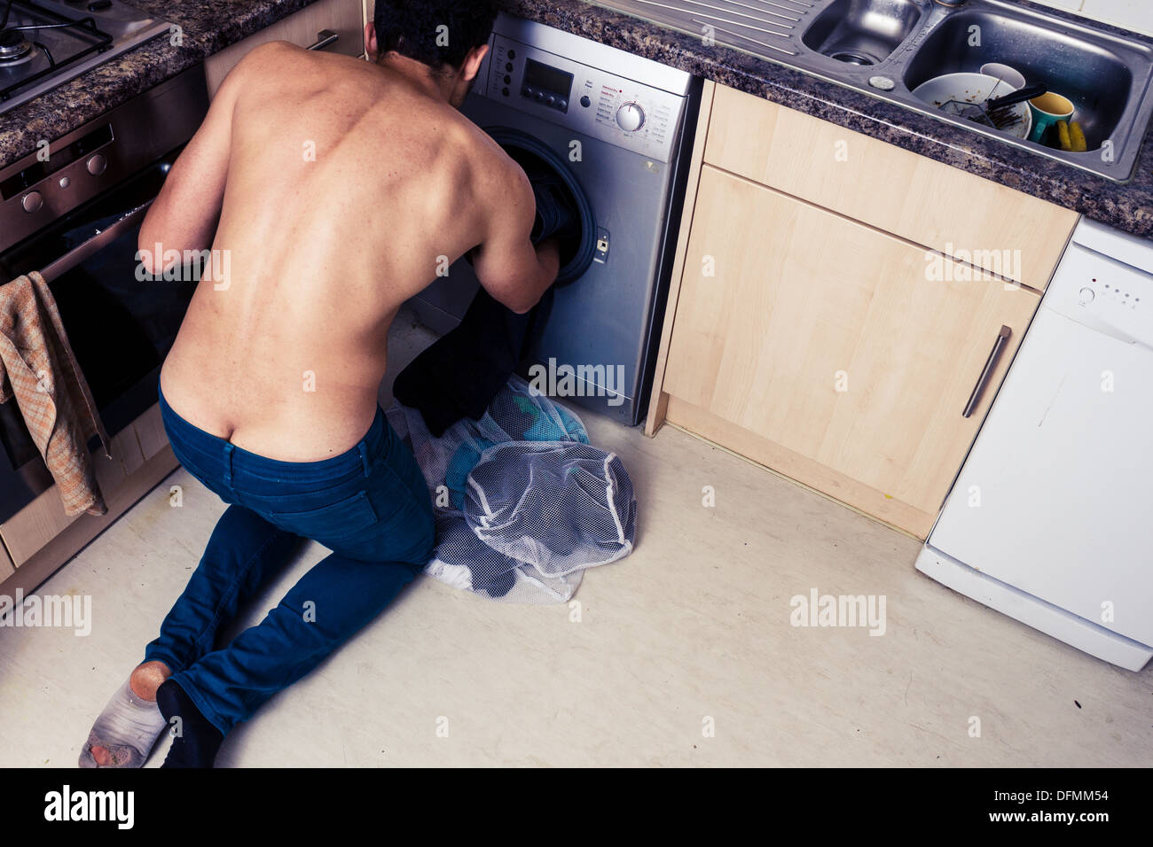 Young man doing laundry Stock Photo