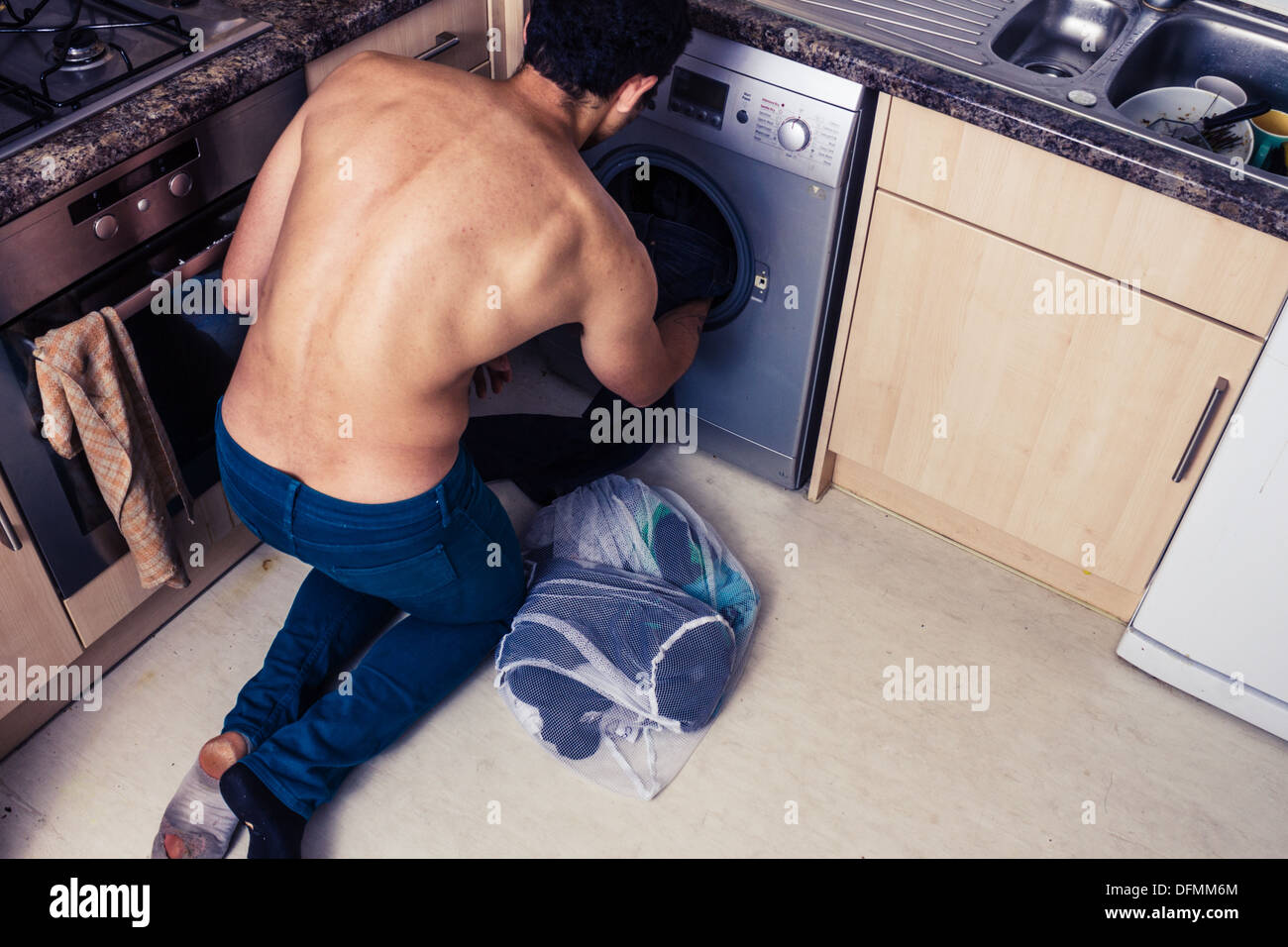 Young man doing laundry Stock Photo
