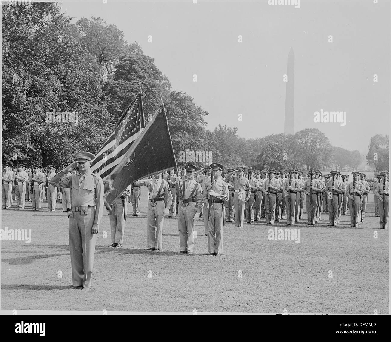 This photograph depicts a color guard and troops taking part in the welcoming ceremonies for French General Charles de Gaulle. The event highlights military honor and international diplomacy during a significant visit. Stock Photo