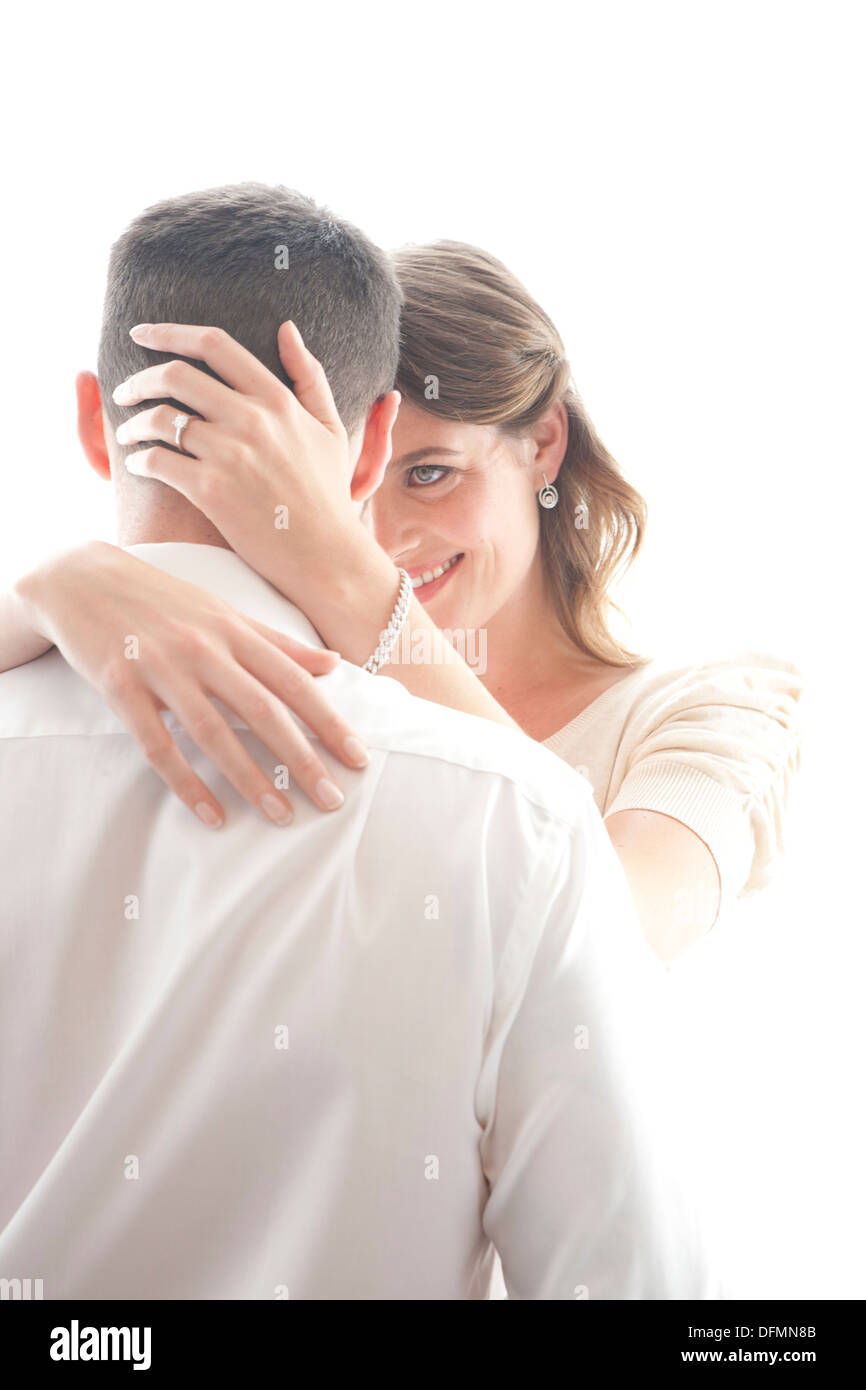 High key image of a late 20s/early 30s male and female couple embracing and in love Stock Photo