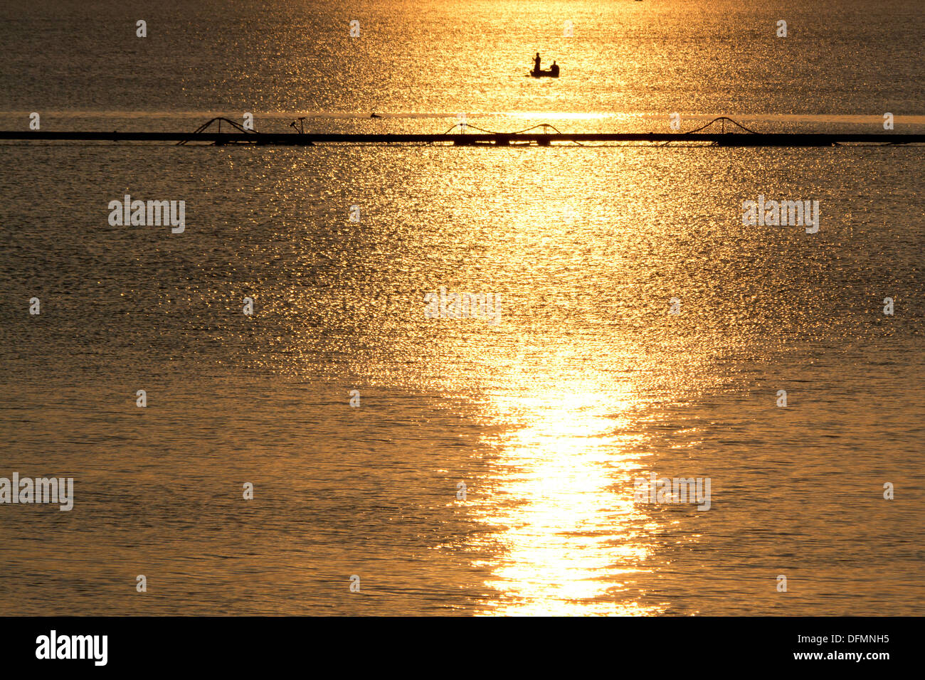 Silhouette of boat fishing on the lake at sunset Stock Photo - Alamy