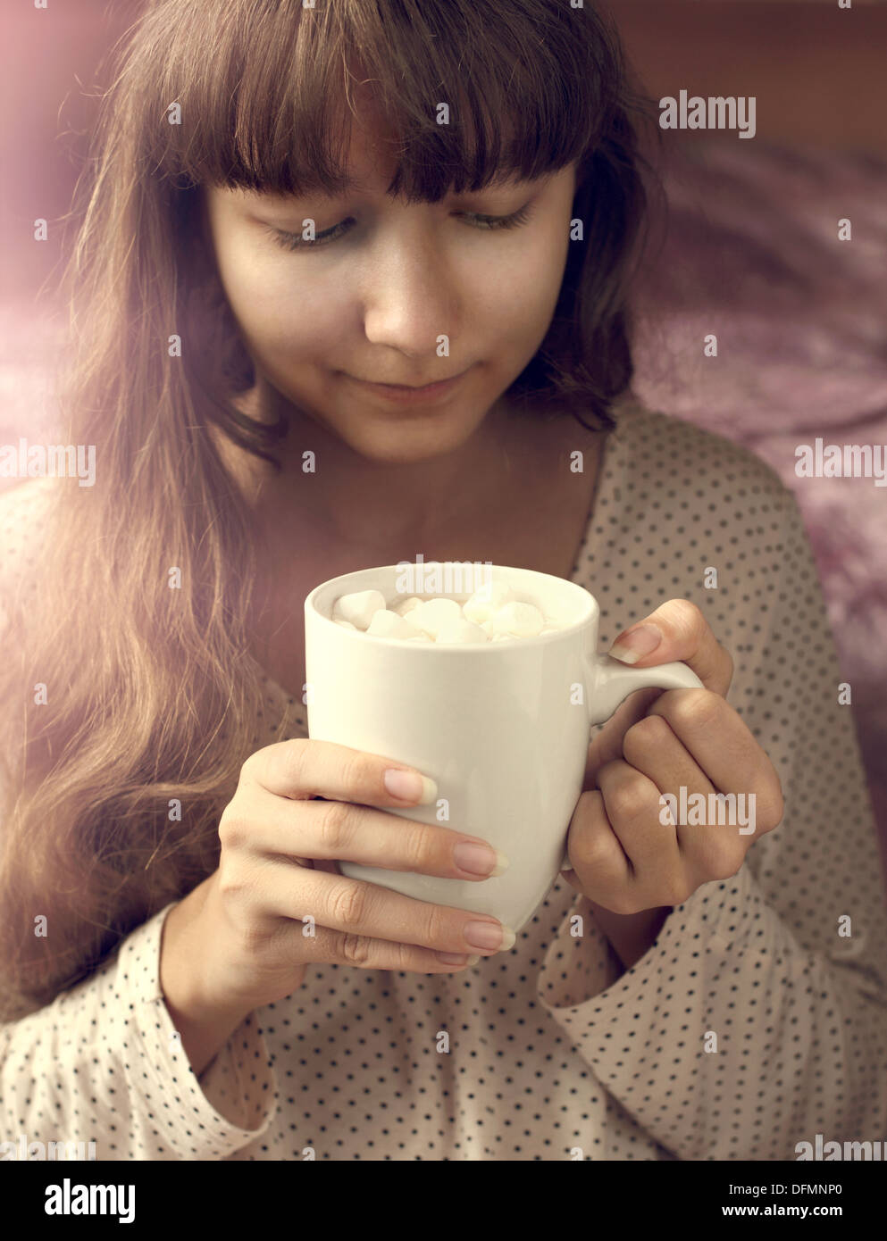 Young girl and cup of hot chocolate with marshmallows in the morning Stock Photo