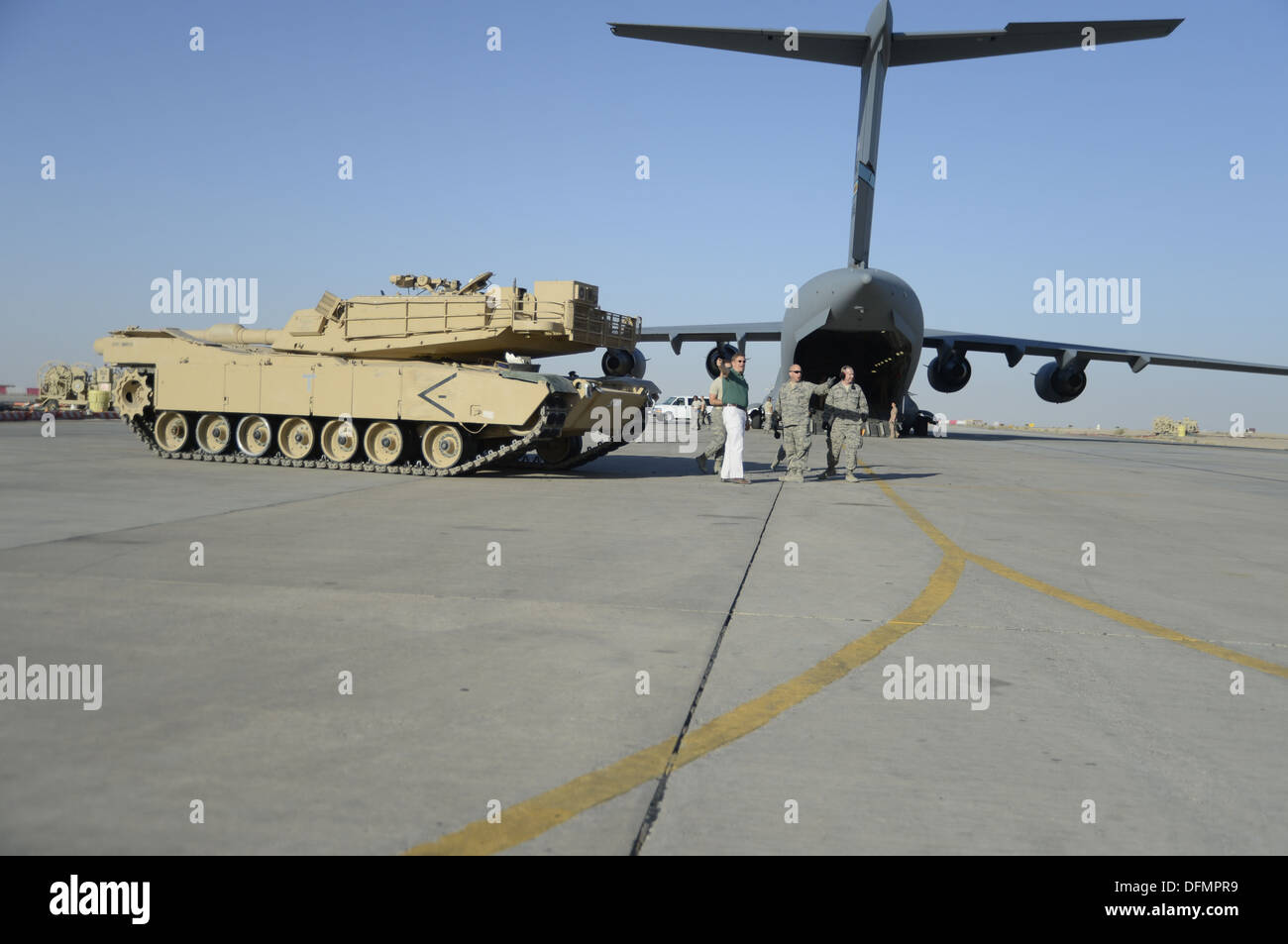 Members of the 386th Air Expeditionary Wing monitor the offload of a M1 Abrams tank from a C17