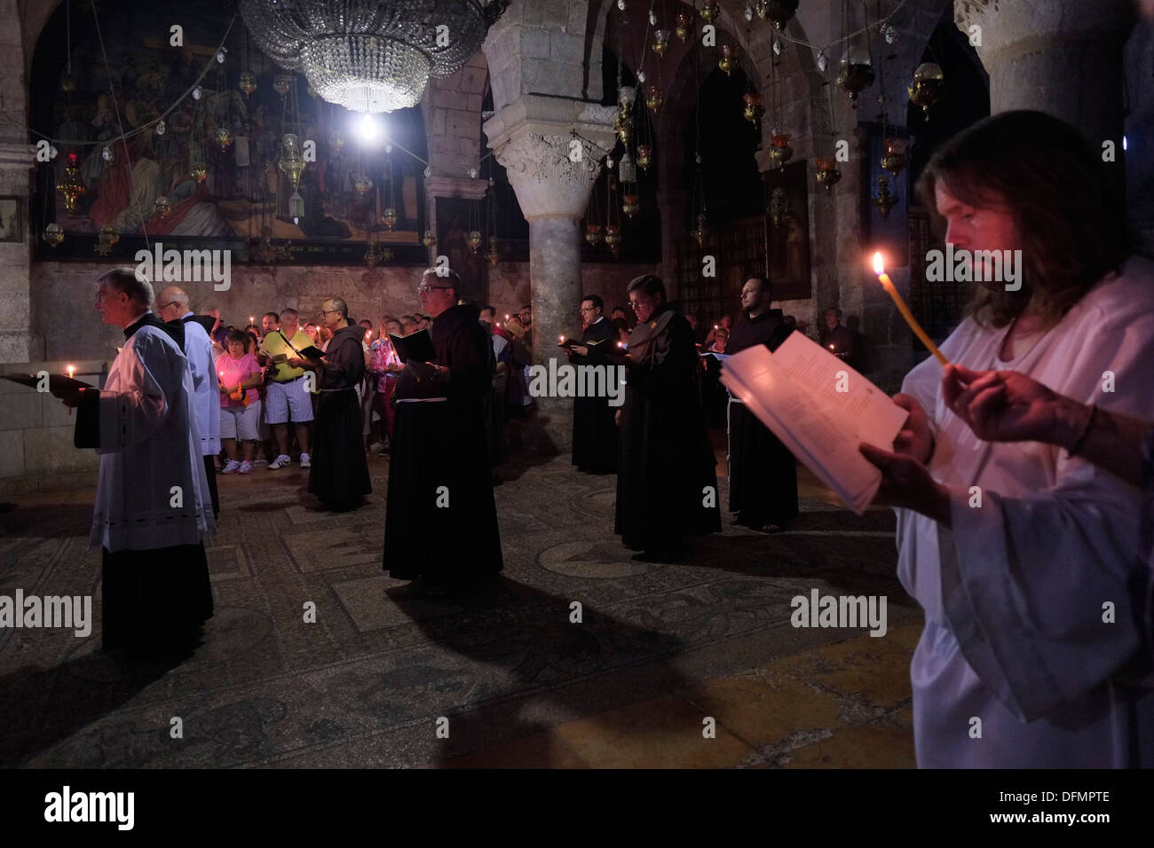 Franciscan priests and friars taking part in a Roman catholic mass procession at the Chapel of St. Helena inside the Holy Sepulchre church in the Christian quarter old city East Jerusalem Israel Stock Photo
