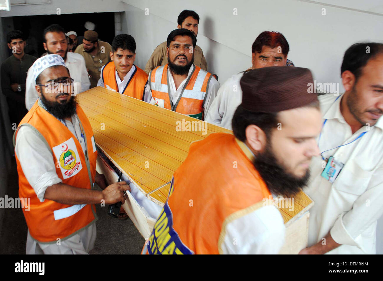 Rescue officials shift dead body of bomb explosion near a hospital at Sulemankhel area victims, at local hospital in Peshawar on Monday, October 07, 2013. At least two persons were killed and 12 injured in an explosion followed by firing at Sulemankhel. Police said that the bomb exploded near a hospital and hit a police mobile that had arrived for protecting a polio vaccination team to whom the vaccination materials were being distributed inside the hospital. Credit:  Asianet-Pakistan/Alamy Live News Stock Photo