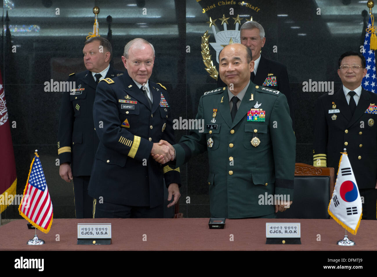Chairman of the Joint Chiefs of Staff Gen. Martin E. Dempsey and his South Korean counterpart Gen. Jung Seung Jo shake hands after signing updated security agreements after a 38th Military Committee meeting in Seoul, South Korea Sept. 30, 2013. Dempsey is Stock Photo