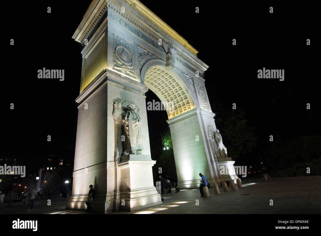 New York City's Washington Arch illuminated at night as seen from 5th Ave looking South into Washington Sq Park Stock Photo