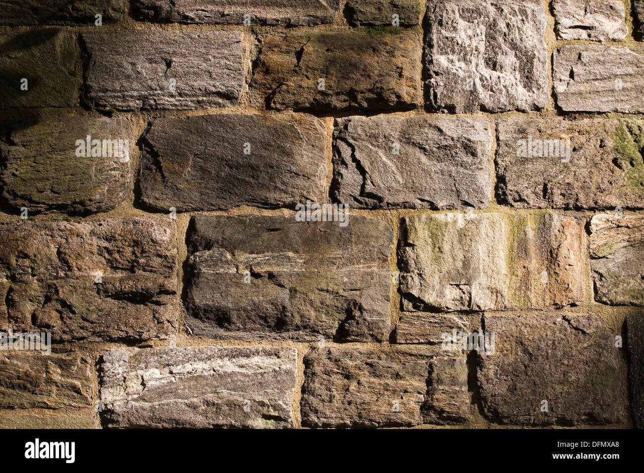 Masonry wall constructed of large blocks of naturally occurring New York Schist stone of various sizes Stock Photo