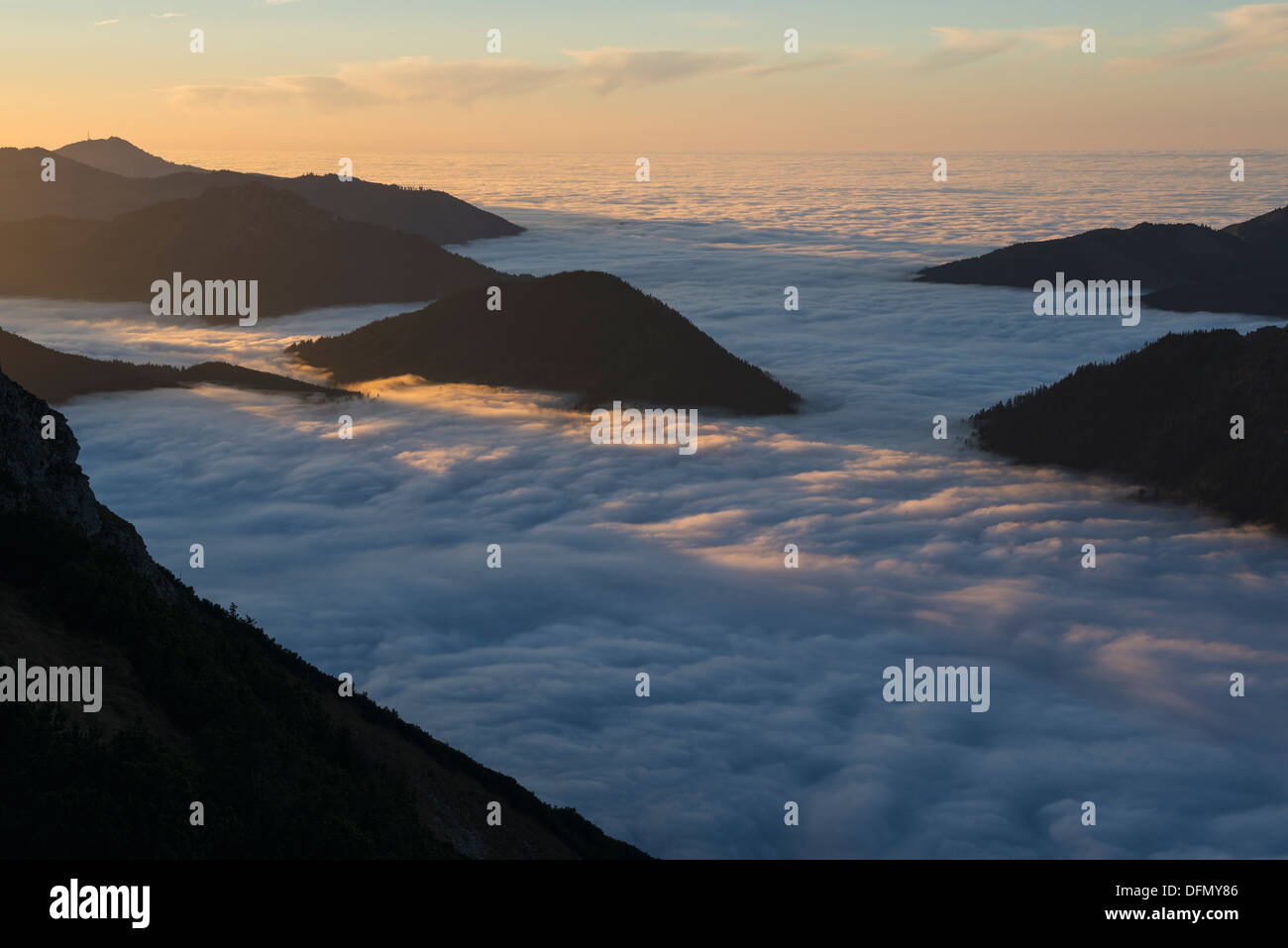 Mountains emerge above inversion layer fog, from summit of Breitenberg, AllgÃ¤u, Bavaria, Germany Stock Photo