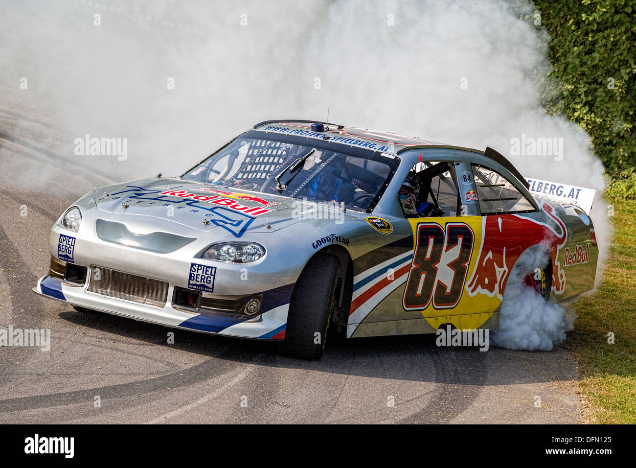 2007 Toyota Camry NASCAR does a burn-out with at the 2013 Goodwood Festival of Speed, Sussex, UK. Stock Photo