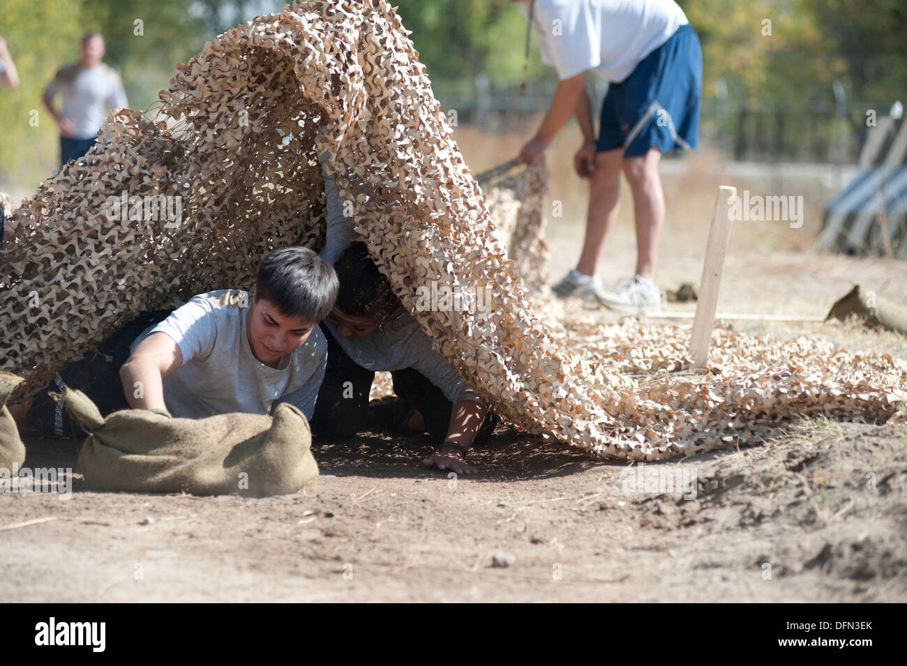 Tech. Sgt. Wendy Corbett low-crawls during the 'Filthy 5K' event at Transit Center at Manas, Kyrgyzstan, Sept. 29, 2013. Corbett is a member of the 376th Expeditionary Security Forces Squadron deployed out of Maxwell Air Force Base, Ala., and a native of Stock Photo