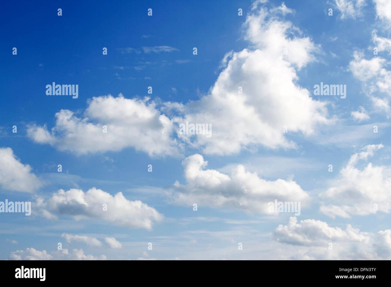 Fluffy white clouds in a blue sky Stock Photo