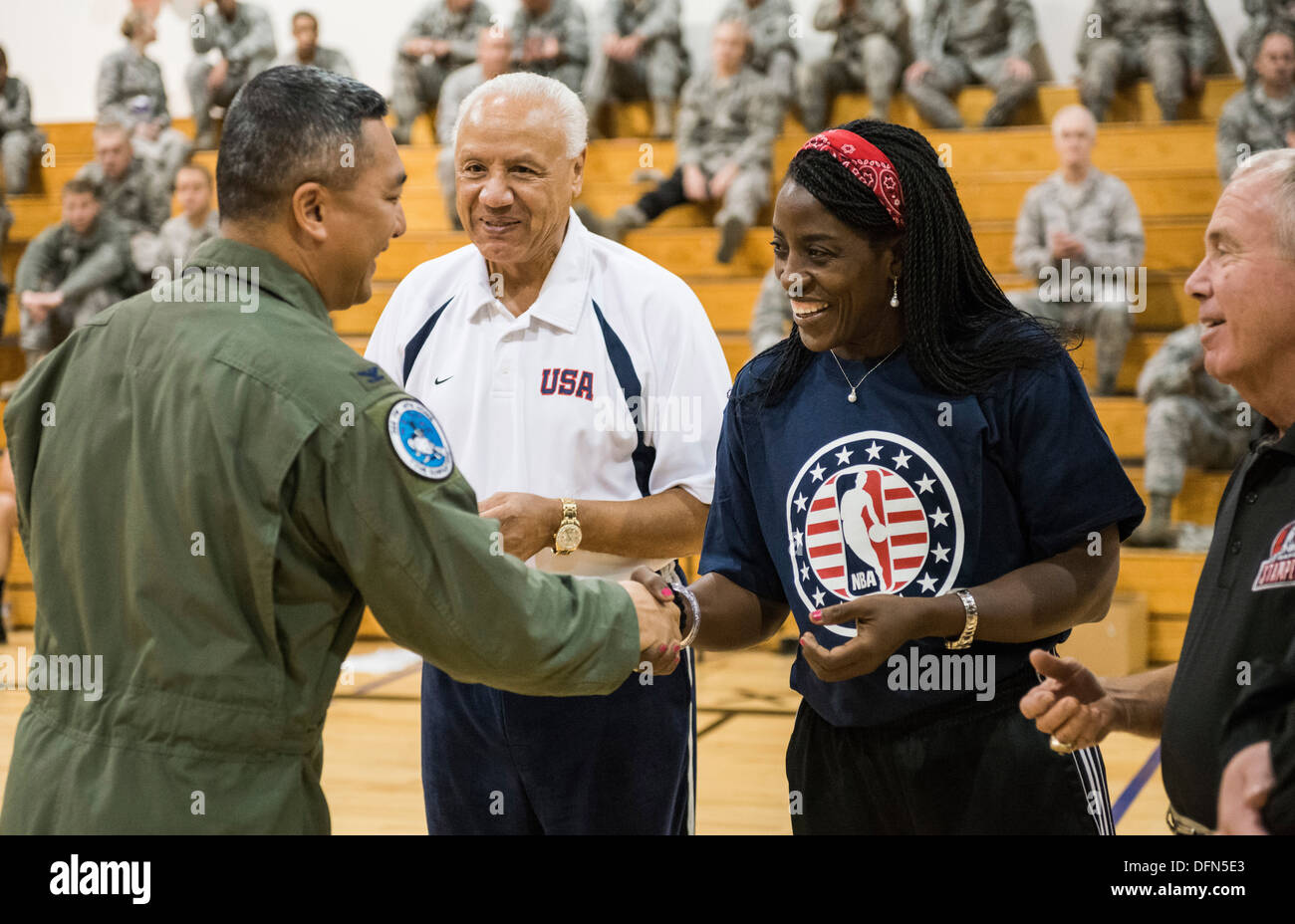 Col. Sarady Tan (left), 366th Medical Group commander, presents a 366th Fighter Wing challenge coin to WNBA star Ruthie Bolton following a five-on-five basketball game at Mountain Home Air Force Base, Idaho, Oct. 4, 2013. Bolton, along with NBA legend Len Stock Photo