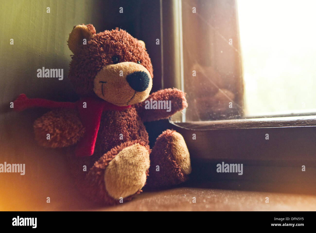 Teddy bear toy sitting by the window Stock Photo - Alamy