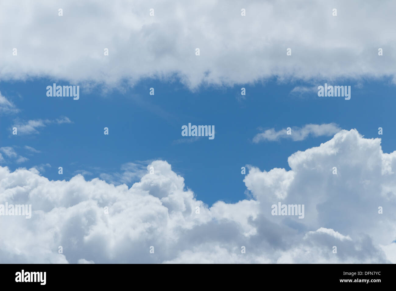 Fluffy clouds in a bright Summer blue sky Stock Photo - Alamy