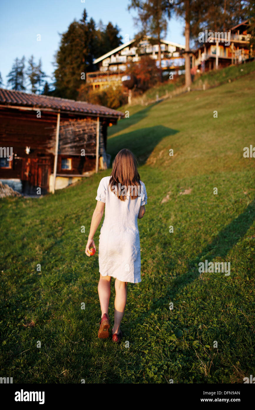 Woman walking over a meadow, Am Hochpillberg, Schwaz, Tyrol, Austria Stock Photo