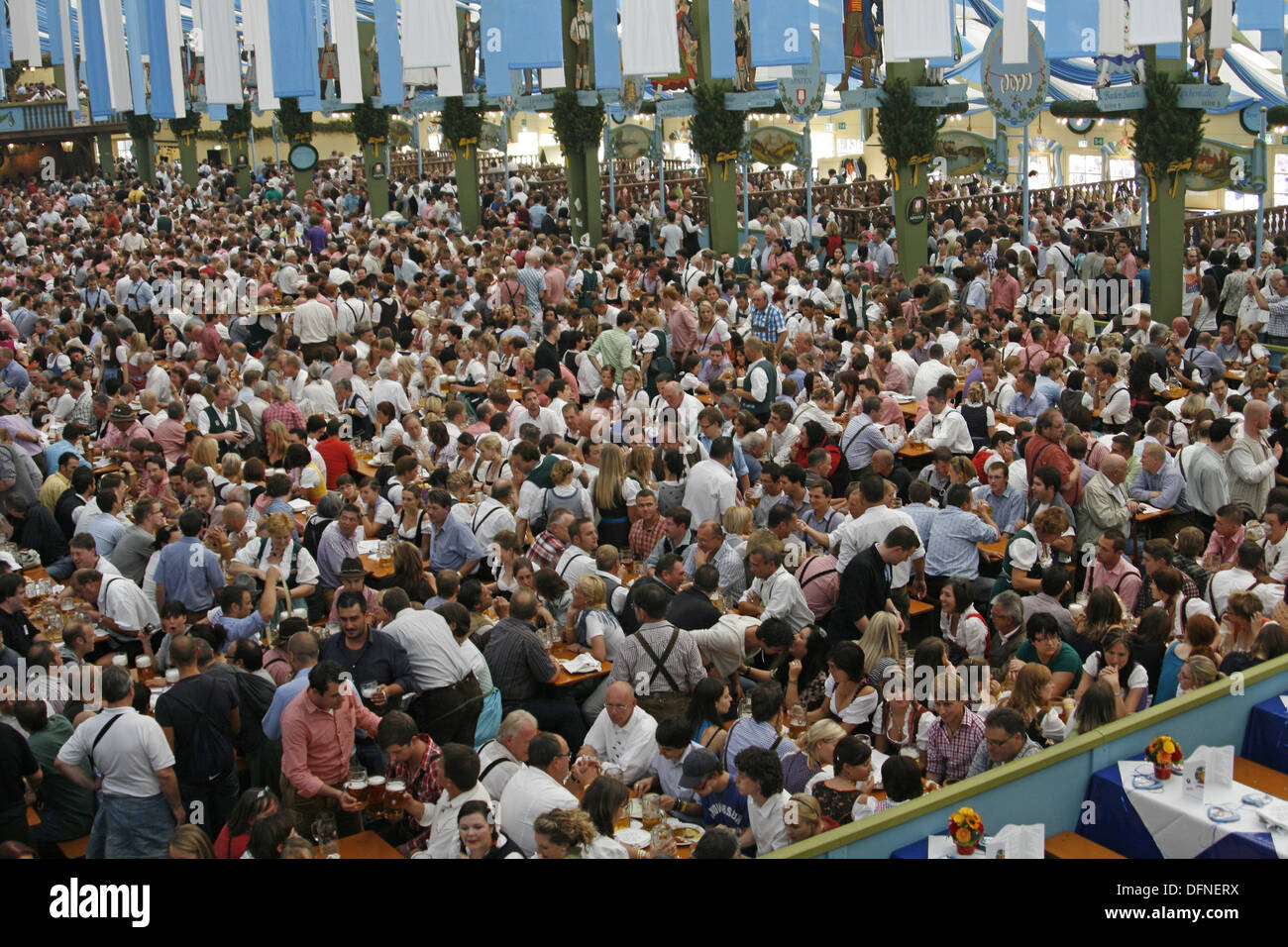 Germany Bavaria Munich Octoberfest large crowd group men and women in Bavarian costume enjoying a beer in an Oktoberfest Stock Photo