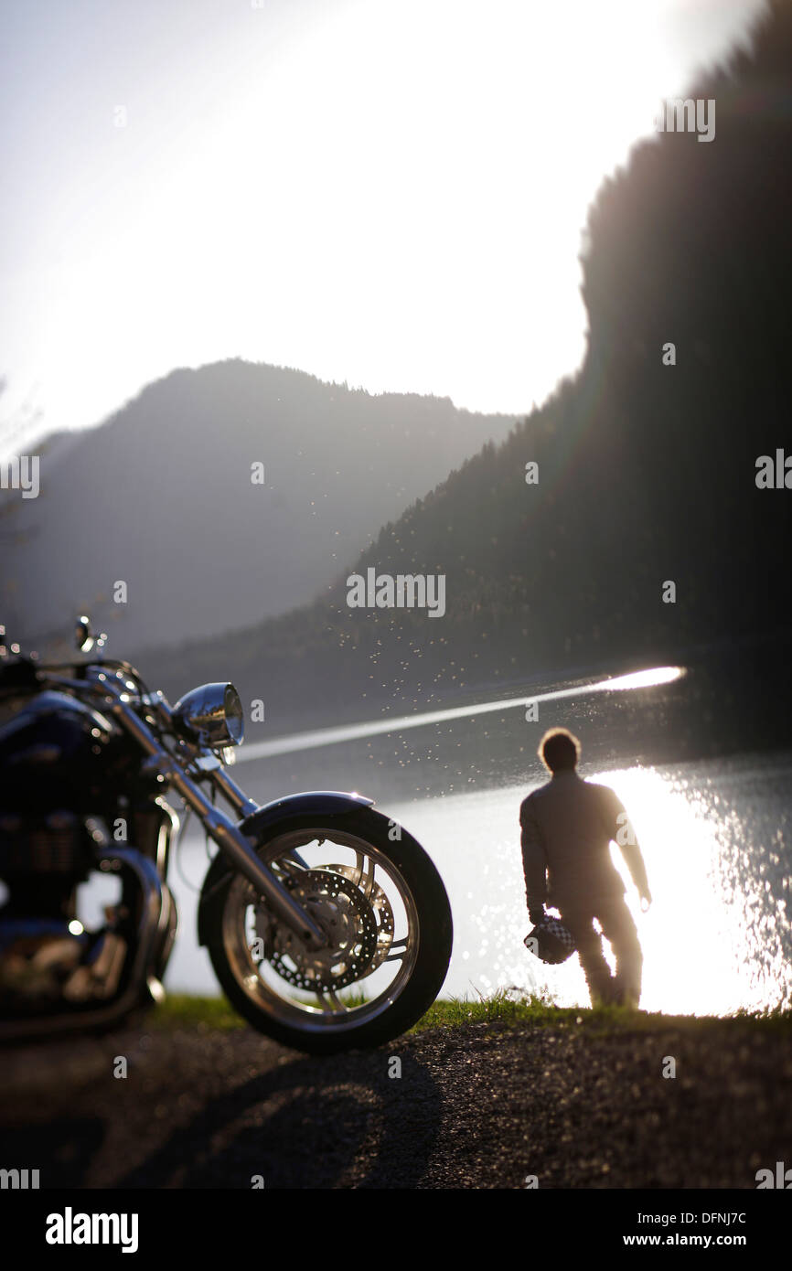 Motorbike tours around Garmisch, Person having a rest at Sylvenstein Reservoir, Upper Bavaria, Bavaria, Germany Stock Photo