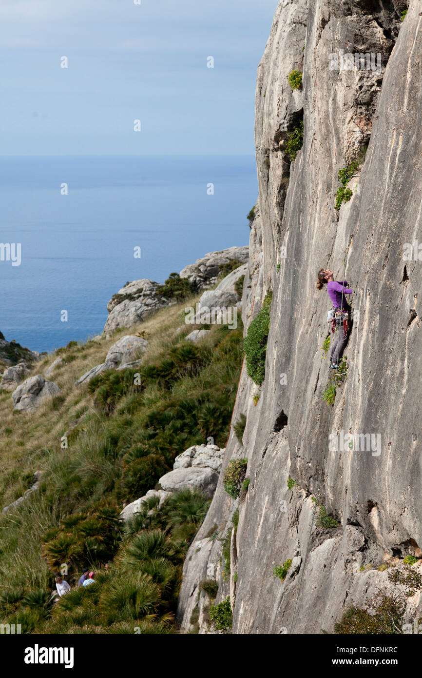 Young women climbing in a steep wall, hiking and climbing on Mallorca, climbing area La Creveta, Cap Formentor, Mediterranean Se Stock Photo