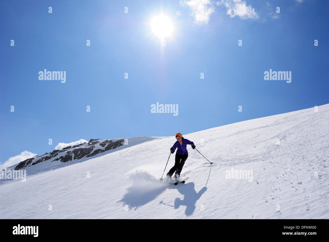 Woman backcountry skiing, descending on snow face, Schesaplana, Raetikon, Montafon, Vorarlberg, Austria Stock Photo