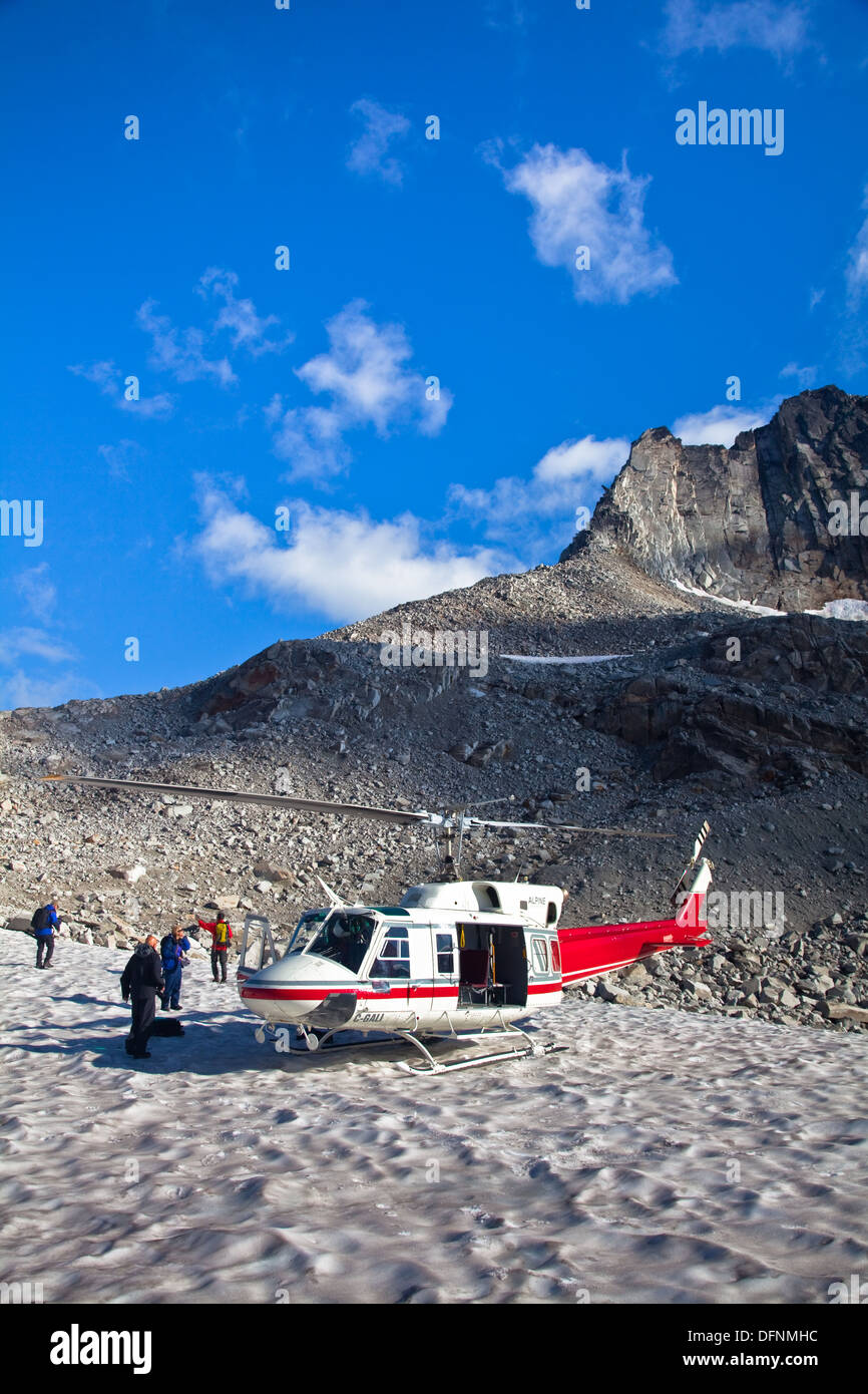 Group of photographers delivered by helicopter to the Vowell glacier in the Bugaboo Mountains, Canada Stock Photo
