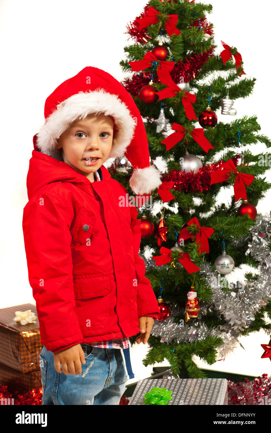 Cheerful Christmas boy standing near tree in his home Stock Photo - Alamy