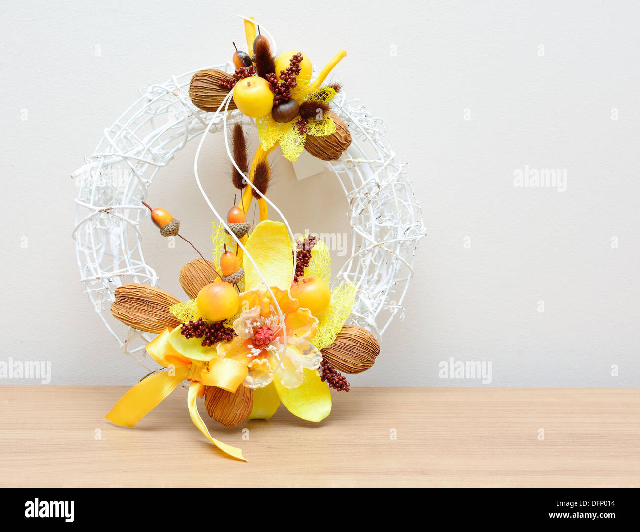 Closeup shot with autumn decoration on the table. Wreath with nuts and acorns. Stock Photo
