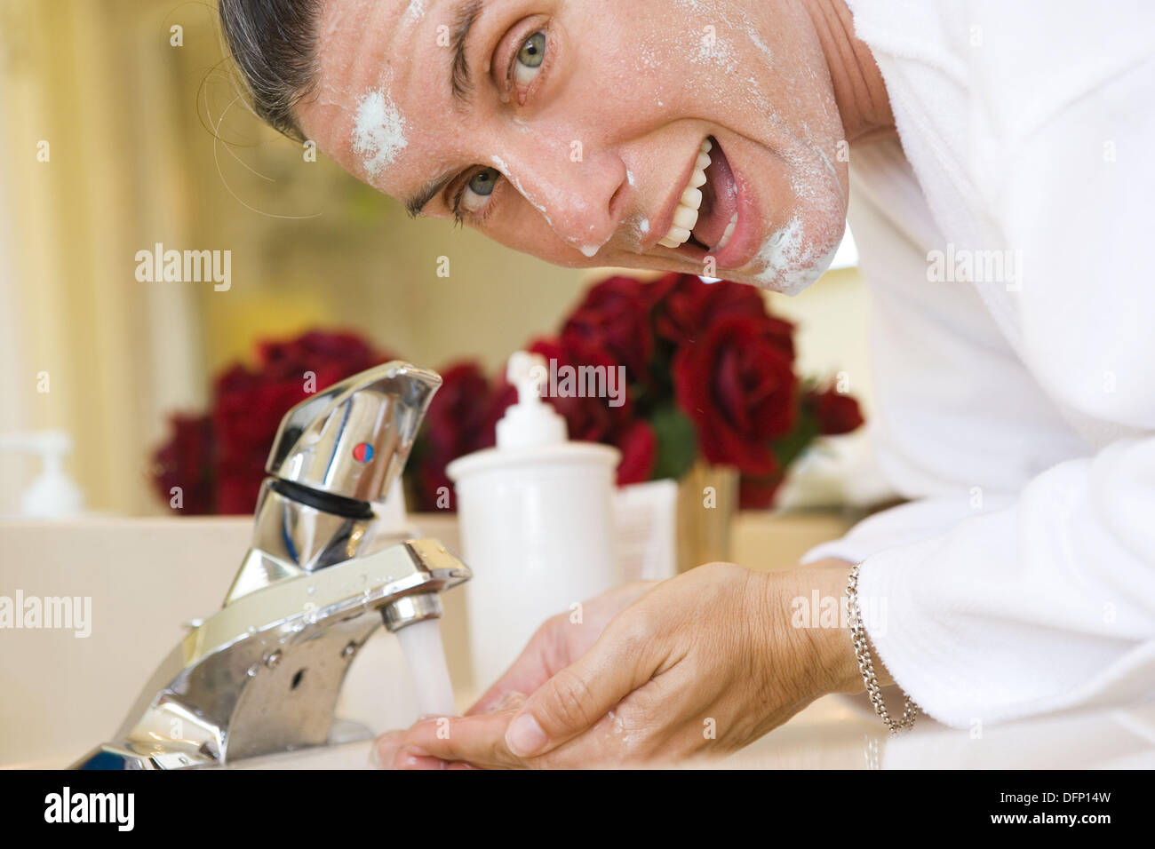 Woman washing face in the bathroom Stock Photo Alamy