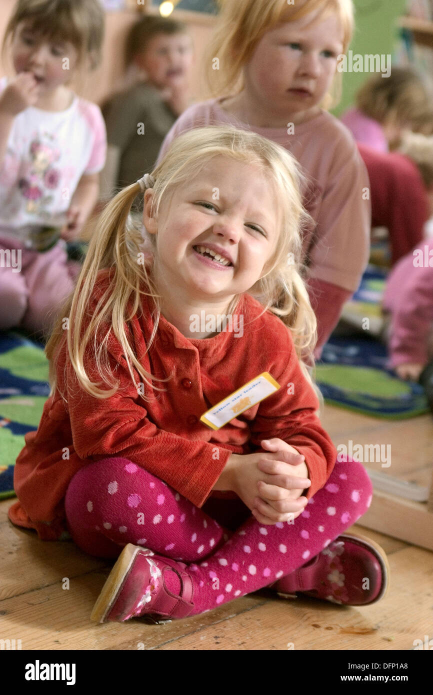 https://c8.alamy.com/comp/DFP1A8/three-year-old-girl-sitting-on-the-floor-at-nursrey-school-smiling-DFP1A8.jpg