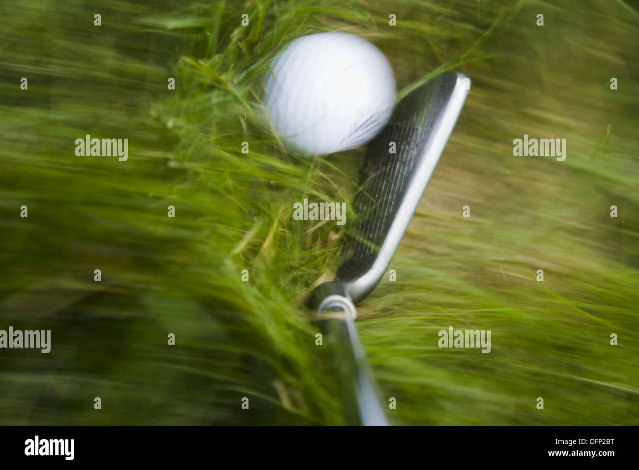 GOLF Blurred motion of club and golf ball in heavy grass on course in Deerfield, Illinois Stock Photo