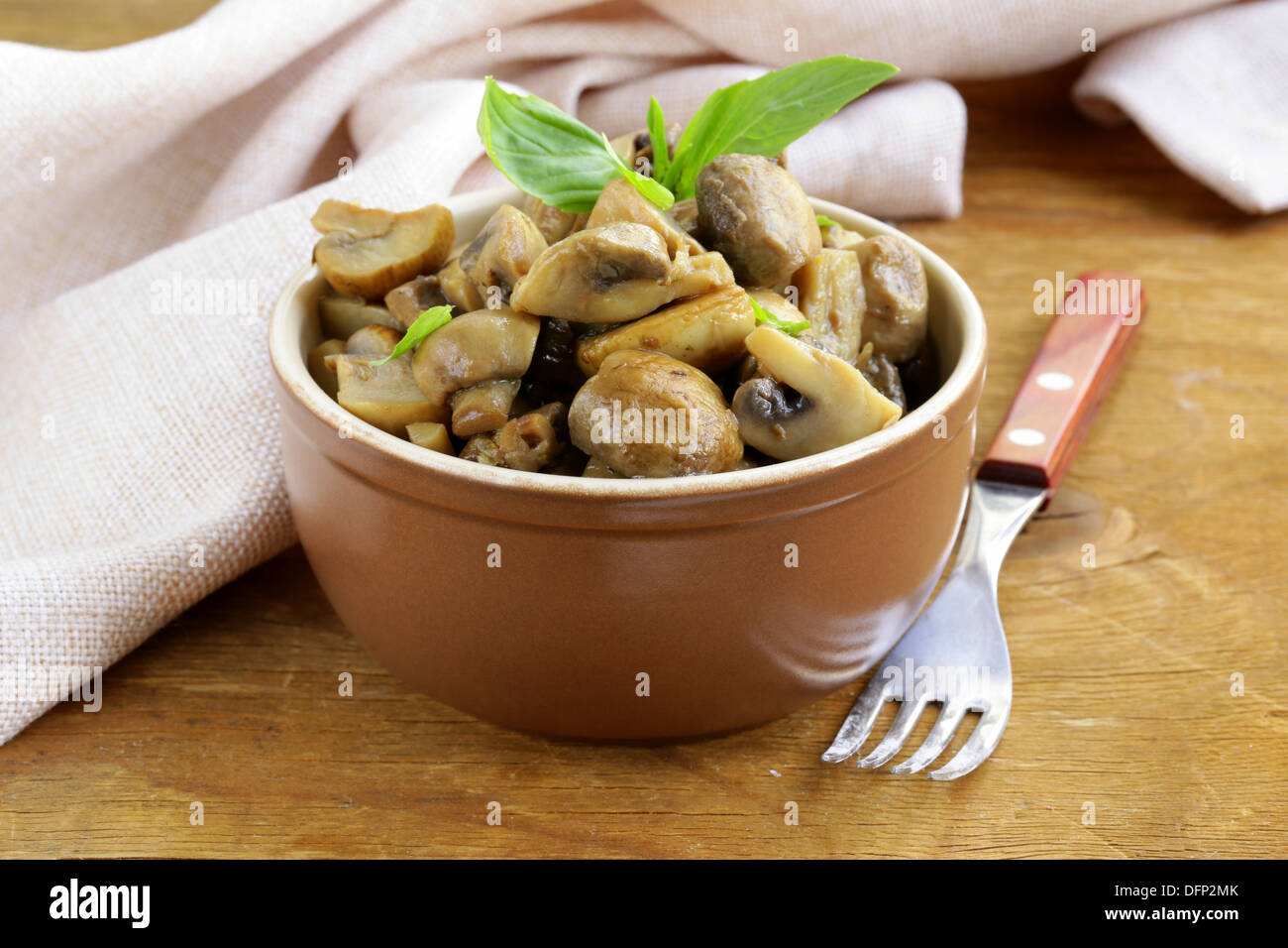mushroom ragout of champignons and basil on a wooden table Stock Photo ...