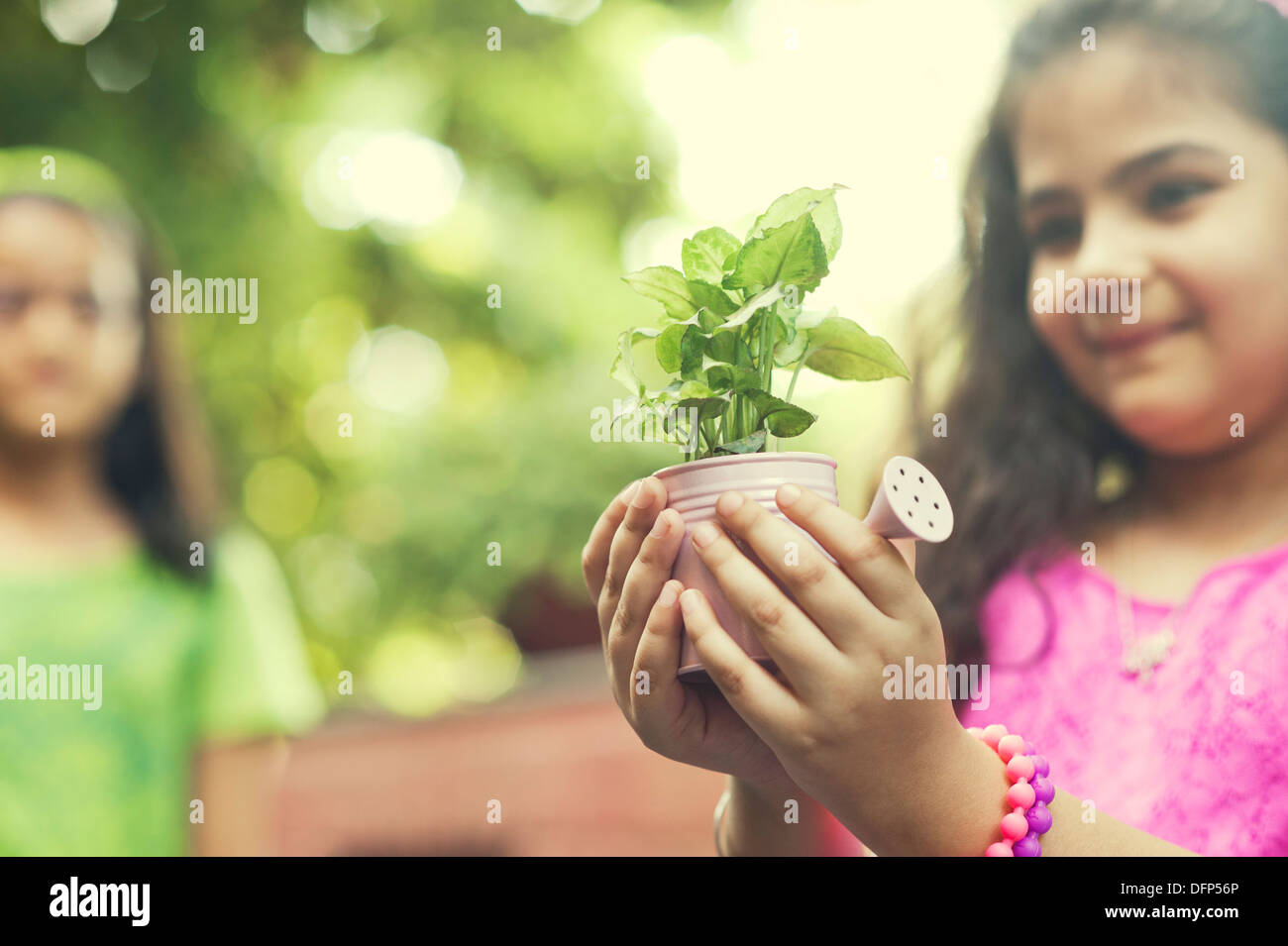 Close-up of a girl holding a potted plant Stock Photo - Alamy