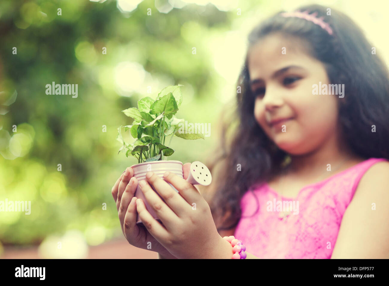 Girl holding potted plant hi-res stock photography and images - Alamy