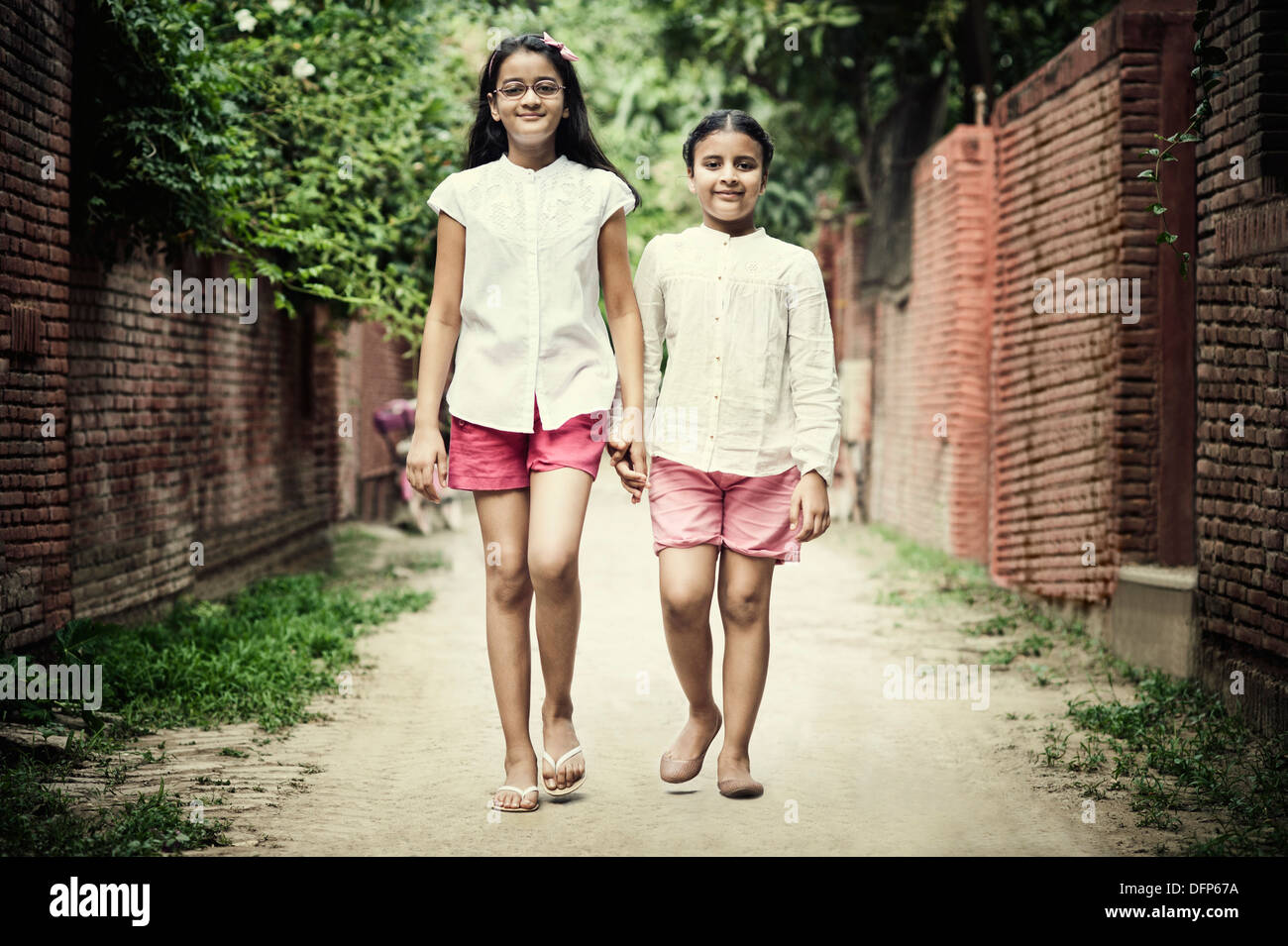 Portrait of two girls walking on the street Stock Photo - Alamy