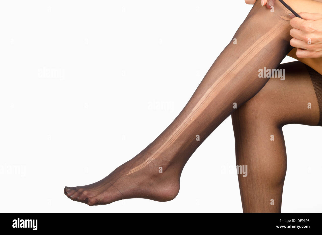 Female legs with a ripped pantyhose on Stock Photo - Alamy